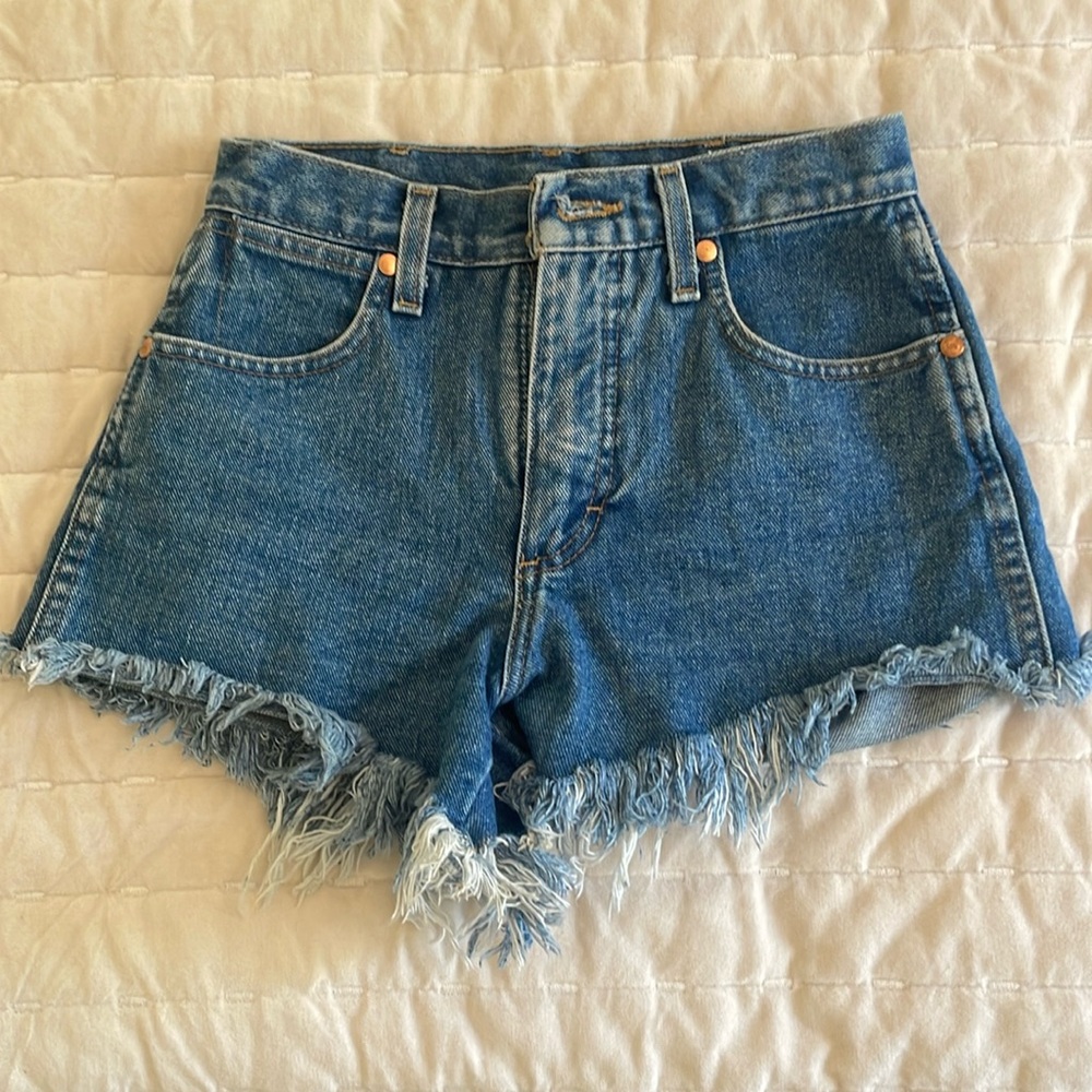 Size 24  blue denim Wrangler daisy duke shorts.